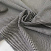 Pure wool with a pied de poule design in the shades of antique white and black sand. Stiff and rough, ideal for coats, jackets, and structured skirts. High-quality deadstock collected in Stock from a Maison de Couture in Italy.