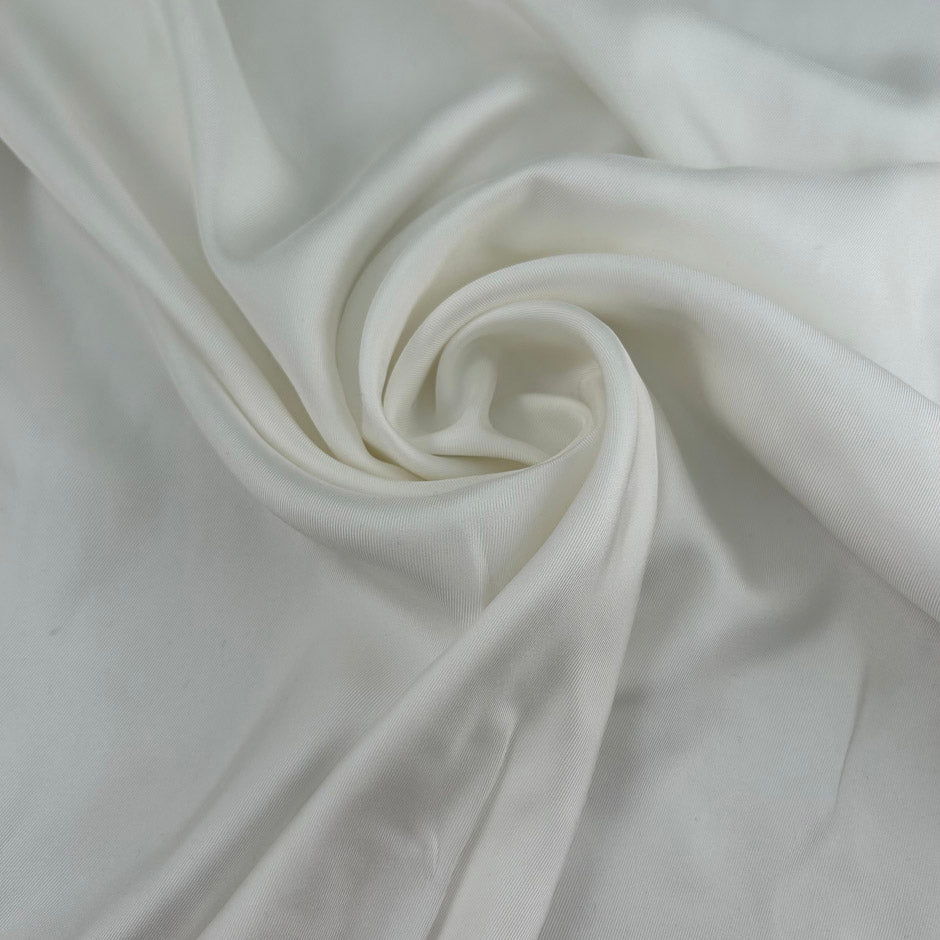 White pure silk twill, soft, fluid and non-stretch. Perfect for dresses and blouses. High-quality deadstock collected in Stock from a Maison de Couture in Italy.