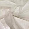 Soft polyester tulle in white with sparkling glitters. Light and delicate, perfect for dresses, skirts, blouses, and shirting.High-quality deadstock collected in Stock from a Maison de Couture in Italy.