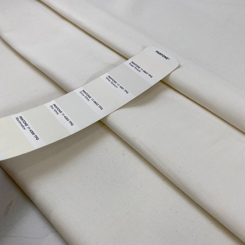 Stretch cotton gabardine in neutral white. Structured and solid. High-quality deadstock collected in Stock from a Maison de Couture in Italy.