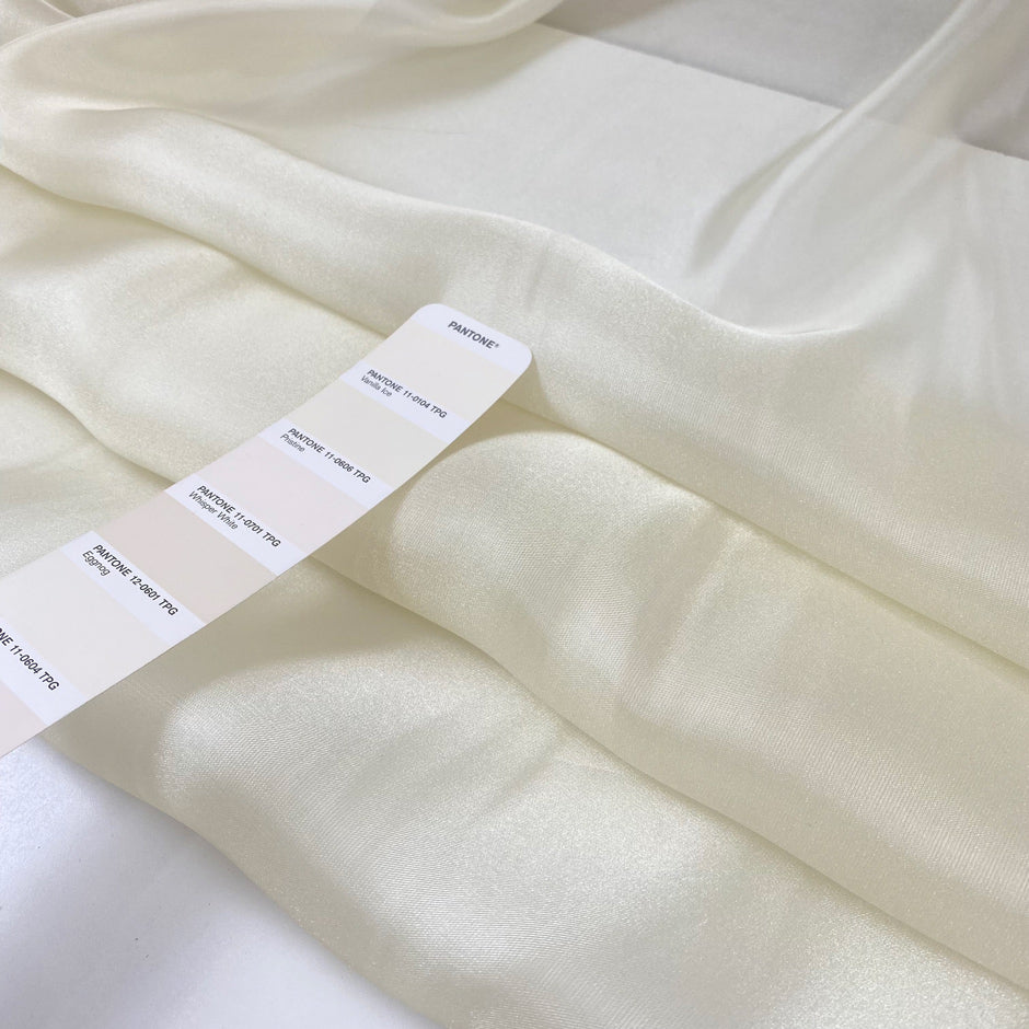 Vanilla ice white and shiny charmeuse polyester;&nbsp; very soft, light, and transparent. High-quality deadstock fabric collected in Stock from a Maison de Couture in Italy.