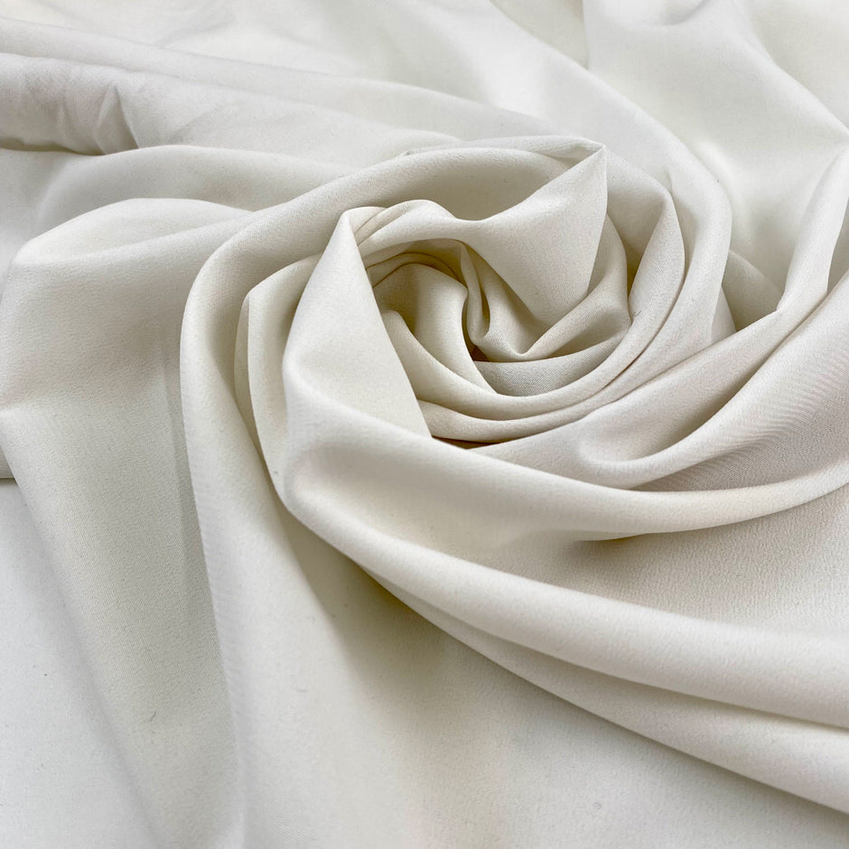 Polyester-like cady in white, very soft, light, and flowy. High-quality deadstock fabric collected in Stock from a Maison de Couture in Italy.