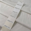 White cotton with elastane in cloudy dancer shade medium weight slightly stiff with striped texture ideal for skirts trousers and jackets. High-quality deadstock collected in Stock from a Maison de Couture in Italy.