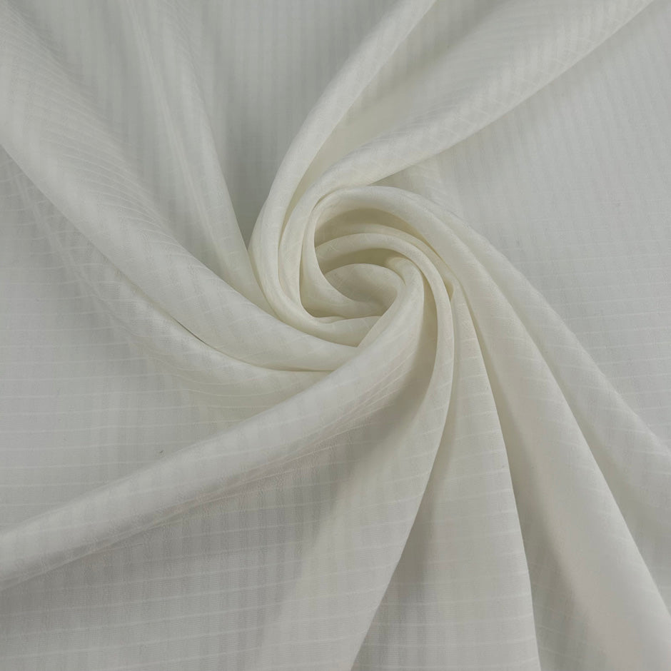 White silk-blend crepe de chine with micro jacquard pattern and non-stretch. High-quality deadstock collected in Stock from a Maison de Couture in Italy.