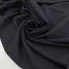 Wool mixed with polyester and elastane featuring a check design in dark blue. Very soft, light, flowy, and not transparent. Ideal for trousers, skirts, and jackets. High-quality deadstock collected in Stock from a Maison de Couture in Italy.