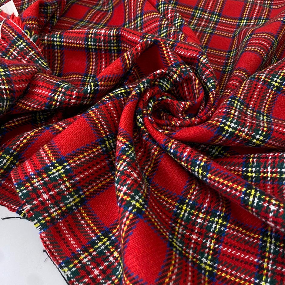 Tartan fabric in a soft wool and polyester blend with a classic Scottish design in shades of red, blue, white, and green. Very soft and warm, ideal for dresses, skirts, and light jackets. High-quality deadstock collected in Stock from a Maison de Couture in Italy.