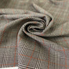 Pure virgin wool with a Prince of Wales check featuring a subtle red line. The pattern combines black, white, and orange tones for a bold yet timeless look. Ideal for jackets, skirts, and dresses. High-quality deadstock collected in Stock from a Maison de Couture in Italy.