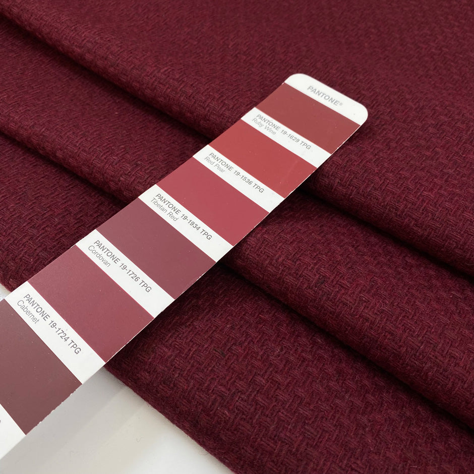 Wool and polyester tweed is heavy in bordeaux and textured. High-quality deadstock fabric by the meter collected in Stock from a Maison de Couture in Italy.