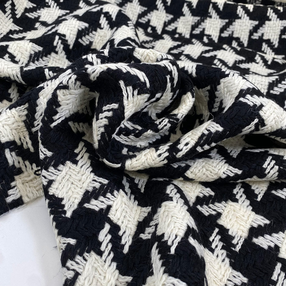 Pure wool with pied de poule design in black and white, color reference Pirate Black and Marshmallow. Heavy and structured, ideal for coats and jackets. High-quality deadstock collected in Stock from a Maison de Couture in Italy.