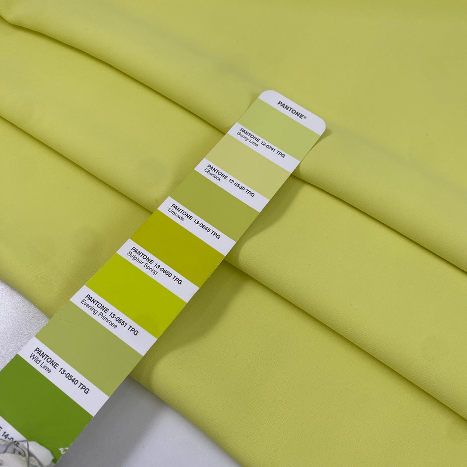 Polyester cady in bright yellow, color reference Sunny Lime. Very soft, light, and flowy, not transparent. Ideal for trousers, dresses, and skirts. High-quality deadstock collected in Stock from a Maison de Couture in Italy.