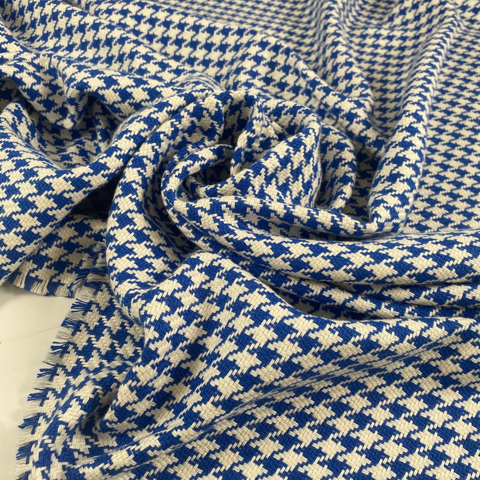 Mixed cotton tweed with a white ground and blue pied de poule pattern, color reference Victoria Blue. Very soft, light, flowy, and not transparent. Ideal for dresses, trousers, skirts, and jackets. High-quality deadstock collected in Stock from a Maison de Couture in Italy.