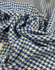 Mixed cotton tweed with a white ground and blue pied de poule pattern, color reference Victoria Blue. Very soft, light, flowy, and not transparent. Ideal for dresses, trousers, skirts, and jackets. High-quality deadstock collected in Stock from a Maison de Couture in Italy.