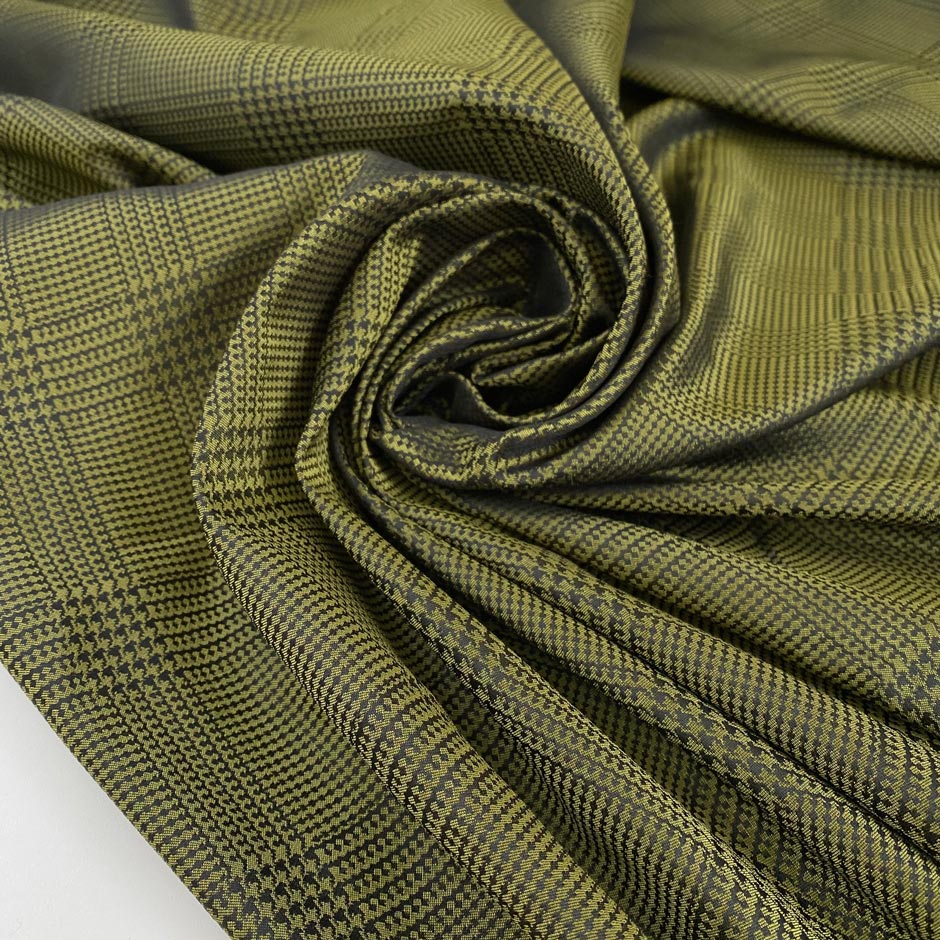 Soft tafta in polyester in olive green with prince of Wales design. High-quality deadstock fabric collected in Stock from a Maison de Couture in Italy.