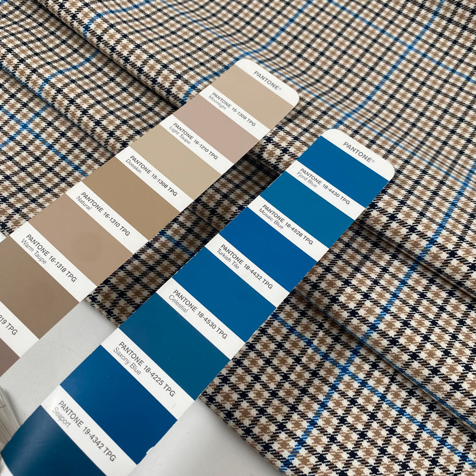 Mixed polyester comfort stretch, with checked design in the shades of beige, color reference natural, and turquoise, color reference fiod blue. A little heavy and flowy, ideal for trousers and jackets. High-quality deadstock collected in Stock from a Maison de Couture in Italy.
