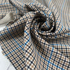 Mixed polyester comfort stretch, with checked design in the shades of beige, color reference natural, and turquoise, color reference fiod blue. A little heavy and flowy, ideal for trousers and jackets. High-quality deadstock collected in Stock from a Maison de Couture in Italy.