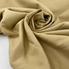 Stretch cotton piqué in very light camel color, with structured textured and very soft. High-quality deadstock fabric by the meter collected in Stock from a Maison de Couture in Italy.