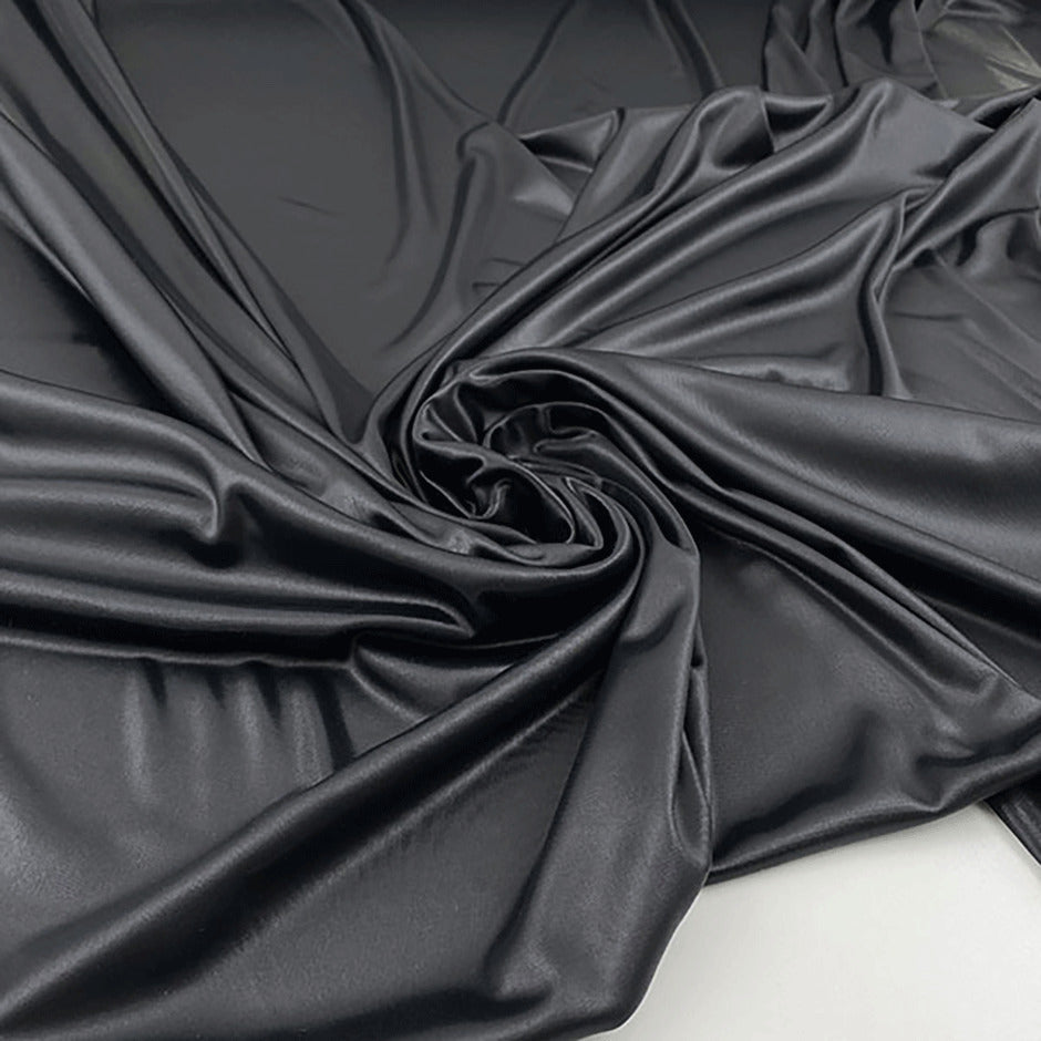 Shiny fluid polyester jersey with leather effect